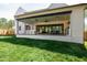 An outdoor kitchen features an outdoor dining table, ceiling fan, and comfortable seating at 4005 Brevard Pl, Raleigh, NC 27609