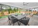 Covered patio with outdoor dining and seating area overlooking the lush backyard, ideal for al fresco dining at 4005 Brevard Pl, Raleigh, NC 27609