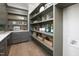 Walk-in pantry with gray custom cabinets, open shelves, and ample storage space at 4005 Brevard Pl, Raleigh, NC 27609