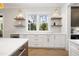 Bright pantry features a window, white cabinets, drawers, and gold hardware at 4005 Brevard Pl, Raleigh, NC 27609