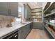 Walk-in pantry with gray custom cabinets, open shelves, and ample counter space at 4005 Brevard Pl, Raleigh, NC 27609