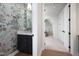 Charming powder room featuring floral wallpaper, a modern vanity with a marble countertop, and an ornate mirror at 4005 Brevard Pl, Raleigh, NC 27609