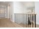 Bright staircase with white wainscoting, black iron railings and hardwood floors at 4005 Brevard Pl, Raleigh, NC 27609