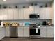Modern kitchen with white cabinets, granite countertops, and stainless steel appliances at 41 Faircox Way # 137, Garner, NC 27529