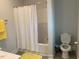 Small, clean bathroom with a yellow rug and shower at 41 South Faircox Way # 137, Garner, NC 27529