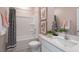 Bathroom featuring a shower/tub combo, white vanity, and modern decor at 701 Lucky Clover Way, Fuquay Varina, NC 27526