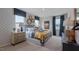 Main bedroom with metal bed frame, patterned wallpaper, and stylish decor at 701 Lucky Clover Way, Fuquay Varina, NC 27526