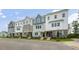 Modern townhouses with gray and white siding, stone accents, and landscaping at 701 Lucky Clover Way, Fuquay Varina, NC 27526