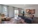 Spacious living room with comfortable seating and access to a deck at 701 Lucky Clover Way, Fuquay Varina, NC 27526