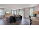 Open concept living area with sectional sofa, media console, and workspace at 701 Lucky Clover Way, Fuquay Varina, NC 27526