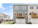 Townhouse rear view showing gray siding, private balcony, and attached garage at 701 Lucky Clover Way, Fuquay Varina, NC 27526