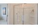 Walk-in shower with glass enclosure and built-in shelves at 701 Lucky Clover Way, Fuquay Varina, NC 27526