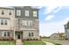Three-story townhome with stone and gray siding at 701 Lucky Clover Way, Fuquay Varina, NC 27526