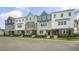 Exterior view of townhomes with gray, white, and brick accents at 701 Lucky Clover Way, Fuquay Varina, NC 27526