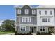 Two-story townhome with gray and white siding, and landscaping at 703 Lucky Clover Way, Fuquay Varina, NC 27526
