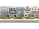 New townhome community featuring three-story townhouses with modern brick and siding at 705 Lucky Clover Way, Fuquay Varina, NC 27526