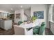 Elegant dining area with marble top table and modern green chairs at 707 Lucky Clover Way, Fuquay Varina, NC 27526