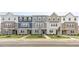 Modern townhomes featuring attractive stone accents, coordinated exteriors, and lush landscaping at 707 Lucky Clover Way, Fuquay Varina, NC 27526