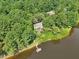 Aerial view showing a house and private dock situated on a tranquil lake at 10305 Old Creedmoor Rd, Raleigh, NC 27613