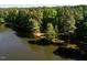 Aerial view of a property with lakefront access and lush greenery at 10305 Old Creedmoor Rd, Raleigh, NC 27613