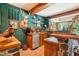 Basement bar with wood cabinetry, stone accents, and a built-in beverage cooler at 10305 Old Creedmoor Rd, Raleigh, NC 27613