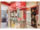Charming bathroom with double sinks, a glass vanity, and red walls at 10305 Old Creedmoor Rd, Raleigh, NC 27613
