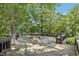 Deck with a stone fire pit, surrounded by lush greenery at 10305 Old Creedmoor Rd, Raleigh, NC 27613