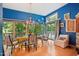 Bright dining room with blue walls, wood floors, and a charming table setting at 10305 Old Creedmoor Rd, Raleigh, NC 27613