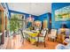 Sun-drenched dining room featuring a yellow table and blue accents at 10305 Old Creedmoor Rd, Raleigh, NC 27613