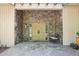 Elegant entryway with stonework, double doors, and a peaceful fountain at 10305 Old Creedmoor Rd, Raleigh, NC 27613