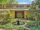 Inviting home exterior featuring stone accents and a charming water feature at 10305 Old Creedmoor Rd, Raleigh, NC 27613