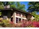 Tan house with stone chimney, surrounded by azaleas at 10305 Old Creedmoor Rd, Raleigh, NC 27613