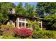 Tan house with stone chimney and azaleas at 10305 Old Creedmoor Rd, Raleigh, NC 27613