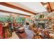 Spacious living room with stone fireplace, wood beams, and comfortable seating at 10305 Old Creedmoor Rd, Raleigh, NC 27613