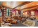 Cozy office with wood-beamed ceiling, leather chair, and wildlife decor at 10305 Old Creedmoor Rd, Raleigh, NC 27613