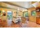Relaxing sitting area with a sofa, terracotta tile floor, and access to a porch at 10305 Old Creedmoor Rd, Raleigh, NC 27613