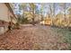 Spacious backyard with a storage shed and bordered by trees; stairs to a raised foundation at 1109 Mays Chapel Rd, Bear Creek, NC 27207