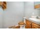 Modest bathroom featuring wood-look floors, vanity with integrated sink, and a standard toilet at 1109 Mays Chapel Rd, Bear Creek, NC 27207