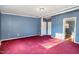 Bedroom with red carpet, baseboard trim, two closets and an en suite bathroom at 1109 Mays Chapel Rd, Bear Creek, NC 27207