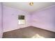Modest purple bedroom with natural light from a single window at 1109 Mays Chapel Rd, Bear Creek, NC 27207