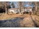 Exterior shot of a house with neutral siding and overgrown front yard at 1109 Mays Chapel Rd, Bear Creek, NC 27207
