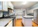 Eat in kitchen featuring white cabinets, stainless steel appliances and an office nook at 1109 Mays Chapel Rd, Bear Creek, NC 27207