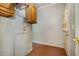 Laundry room with overhead storage and laminate floors at 1109 Mays Chapel Rd, Bear Creek, NC 27207