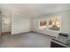 Spacious living room with gray carpet and natural light from two windows overlooking the yard at 1109 Mays Chapel Rd, Bear Creek, NC 27207