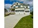 Inviting exterior of a white two-story home with a three car garage and a concrete driveway at 1229 Azalea Garden Cir, Raleigh, NC 27603