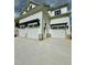 Exterior showcasing a three car garage with stylish pergola and concrete driveway at 1229 Azalea Garden Cir, Raleigh, NC 27603