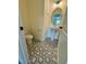 Stylish powder room with geometric tiled floor and pedestal sink at 1229 Azalea Garden Cir, Raleigh, NC 27603