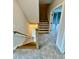 Carpeted stairway with wooden handrail leads to upper level, highlighting a modern chandelier at 1229 Azalea Garden Cir, Raleigh, NC 27603