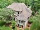 House with a large backyard and surrounding trees at 1300 Caistor Ln, Raleigh, NC 27614