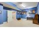 Finished basement room with blue walls, a desk, and Star Wars movie posters at 1300 Caistor Ln, Raleigh, NC 27614